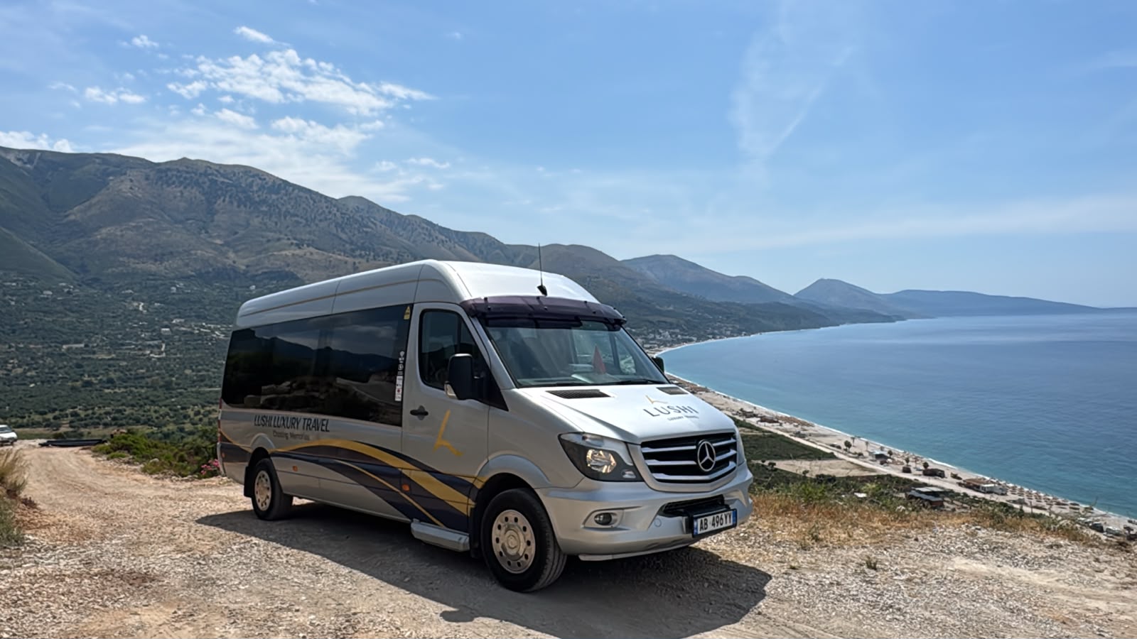 Our 13-seater Mercedes-Benz Sprinter parked on a coastal road